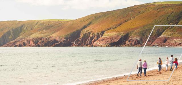 Intergenerational Family Walking on a Beach